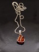 Amber pendant 
1.4 x 2.2 cm. 
mounted in 
sterling silver 
and sterling 
silver chain 42 
cm. subject ...