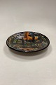 Multicolored 
Stoneware Dish 
with hole for 
wall hanging. 
Artist unknown. 
Possibly signed 
Saqú 68. ...