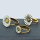 Georg Jensen 
Daisy rings in
gold-plated 
sterling silver 
and white 
enamel. 
Produced by 
Georg ...