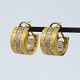 C. Antonsen; 
Ear rings in 
18k gold and 
white gold. 
Diam. 1,7 cm. 
W. 1 cm. 
Stamped "CA ...
