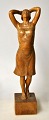 Danish artist 
(20th century): 
Standing woman. 
Carved wooden 
figure. Signed. 
H.: 26 ...