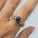 A ring in 18k 
gold set with a 
cabochon sanded 
sapphire and 15 
small diamonds. 
Ring size 56. 
...