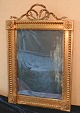 Mirror in a 
gilt frame and 
facet cut 
glass.
Each corner of 
the frame are 
ornamented with 
a ...
