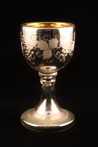 1800th century wine glass made of mercury glass, decorated with etched wine 
leaves outside.