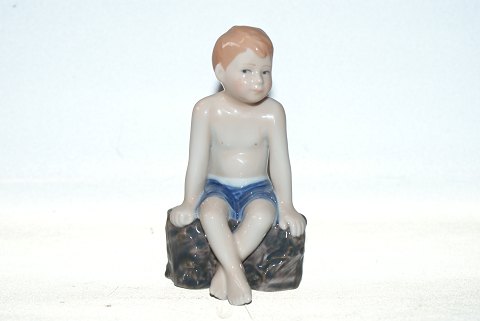 Royal Copenhagen, boy sitting on a rock