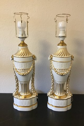 Royal Copenhagen A pair of baluster-shaped lamps on base decorated with 
garlands, Ram heads and gold. With Juliane Marie Stamp from 1905-12. Mounted 
with EL bulbs and wire.