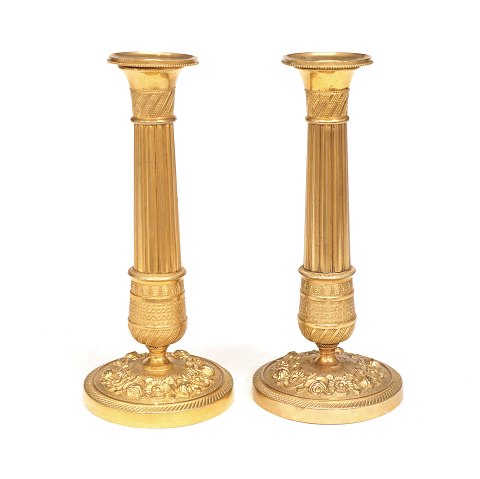 A pair of small gilt bronze candlesticks. France 
circa 1820. H: 19cm