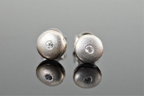 Ear rings set with diamonds mounted in 14k white gold