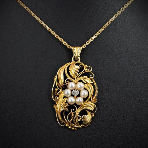 Viggo Wollny; A diamond pendant set with pearls mounted in 14k gold