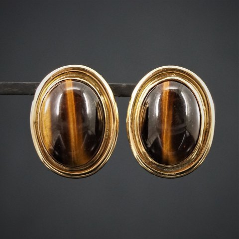 A pair of earrings set with tiger-eye mounted in 14k gold