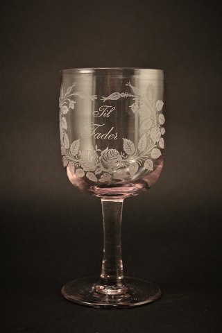 Old commemorative glass from Holmegaard glassworks with fine engraved floral 
decorations and writing "Til Fader" H:16,5cm. Dia:7.5cm.