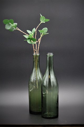 Decorative old glass bottle in green glass 
with a really nice patina in the glass itself. 
Really nice as a vase for a single flower or as water decanters.
