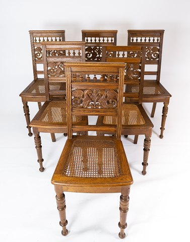 Set of dining room chairs of oak decorated with carvings from the 1920s. 
5000m2 showroom.