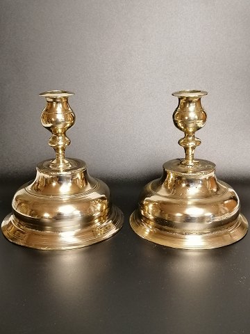 A pair of almost identical brass candlesticks from the early 18th century