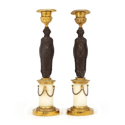 A pair of fire gilt bronze candle sticks. France 
circa 1830. H: 28cm