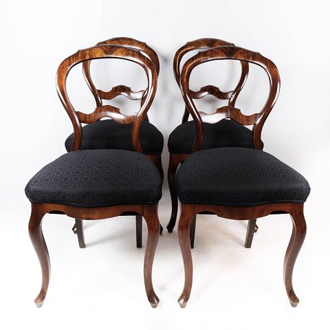 Set of four rococo dining room chairs of dark wood and upholstered with black 
fabric from around 1880.
5000m2 showroom.