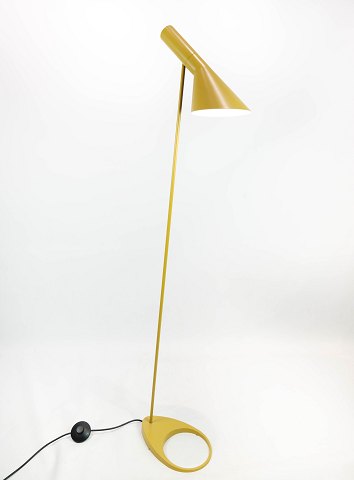 Yellow floor lamp designed by Arne Jacobsen and manufactured by Louis Poulsen. 
5000m2 showroom.