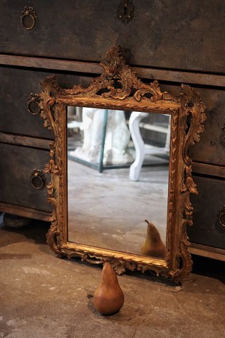 Antique French 1800 century wall mirror with carved gilded wooden frame with 
fine decorations and with a really nice patina...