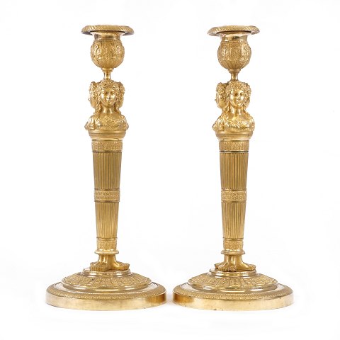 A pair of fire gilt bronze candlesticks. France 
circa 1810. H: 31cm