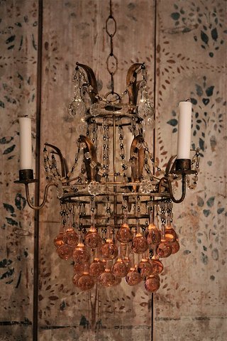 Old French chandelier in gilded metal, decorated with glass chains and glass 
balls in clear and pink colours...