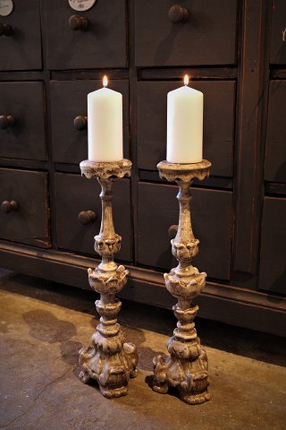 A pair of antique French 19th century wooden candlesticks with remnants of old 
silver coating...