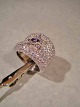Ring.
 With purple 
crystal in the 
center 
surrounded by 
numerous 
brilliant-cut 
crystal.
 Ring ...