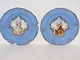 Royal 
Copenhagen.
Two rare 
plates 
decorated with 
portraits of 
noble man and 
noble woman 
from ...