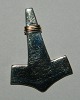 Pendant in 
sterling silver 
in the form of 
Thor's hammer. 
Gold band 
decoration. 
Stamped 925 and 
...