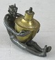 Oil lamp, 19th 
century, in the 
form of seated 
devil with oil 
reservoir in 
brass. Figure 
of ...