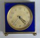 French travel 
alarm clock in 
brass and blue 
enamel, 20th 
century. 7 x 7 
cm. D .: 3 cm.