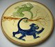 Danish plate in clay, 20th century with decorations in the form of hanging monkeys in a tree. ...