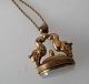 Seal in gold 
plated silver, 
19th century. 
Chain. Seal 
with animal 
heads. Pillow 
in 
semi-precious 
...