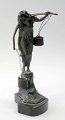 Art Nouveau figure in patinated bronze, approx. 1900. In the form of a woman with a yoke that ...