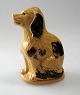 Money bank in 
the form of 
seated dog, 
Bornholm, 
Cocker Spaniel. 
19th century. 
Yellowish and 
...