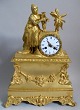 French ormelue 
 fireplace 
clock, c. 1820, 
empire. Square 
base with 
rocailles and 
face. Middle 
...