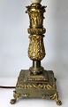 French bronze 
table lamp, 
partly gilded, 
19th century. 
Square base 
with plants and 
legs in the ...