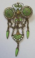 Italian Brooch 
in brass with 
green and white 
enamel, app. 
1900. B .: 3.5 
cm. H .: 6 cm.