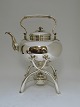 Hot water 
kettle and 
burner. Silver 
(830). Made by 
Samuel Prahl 
(1800-1885). 
Produced 1872. 
...
