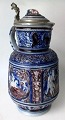 Stoneware 
pitcher, 
Germany, 19th 
century. 
Grayish salt 
glaze with blue 
and violet over 
glaze. ...