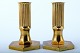 Gusum metal, a pair of candlesticks in brass. 
