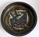 Stoneware dish 
Royal 
Copenhagen, 
Design: Jørgen 
Mogensen. 
Decoration in 
the form of 
bird on a ...