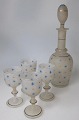 Liqueurs or 
vodka set, 
consisting of 
carafe and 4 
glasses, 19th 
century. Clear 
glass mass ...