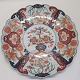 Large Japanese 
Imari dish, 
19th century. 
Wavy edge. 
Bluish 
underglaze. 
Richly 
decorated with 
red ...