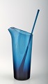 Lemonade 
pitcher with 
stir stick in 
dark blue 
glass, 
modern 
Scandinavian 
design, ...