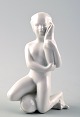 Harald Salomon 
for Rörstrand, 
white glazed 
figure of a sea 
child.
Hallmarked. In 
perfect ...
