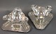 A pair of 
silver gravy 
boats on the 
feet and  on a 
triangular 
silver tray. 
H: 11 cm, Dia: 
21 ...