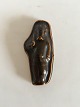 Royal 
Copenhagen 
Stoneware 
Relief figurine 
of man with 
knife. Measures 
9cm.