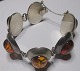 Bracelet in 
sterling silver 
with polished 
pieces of 
amber. Denmark. 
20th century. 
Stamped .: JG. 
...