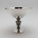 Gundorph 
Albertus, Georg 
Jensen. A 
small, round 
sterling silver 
centre piece 
with round 
foot. H. ...