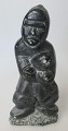 Soapstone Figure, Canada, 20th century. Man with fish. Signed. 665. H .: 15.5 cm. With label ...